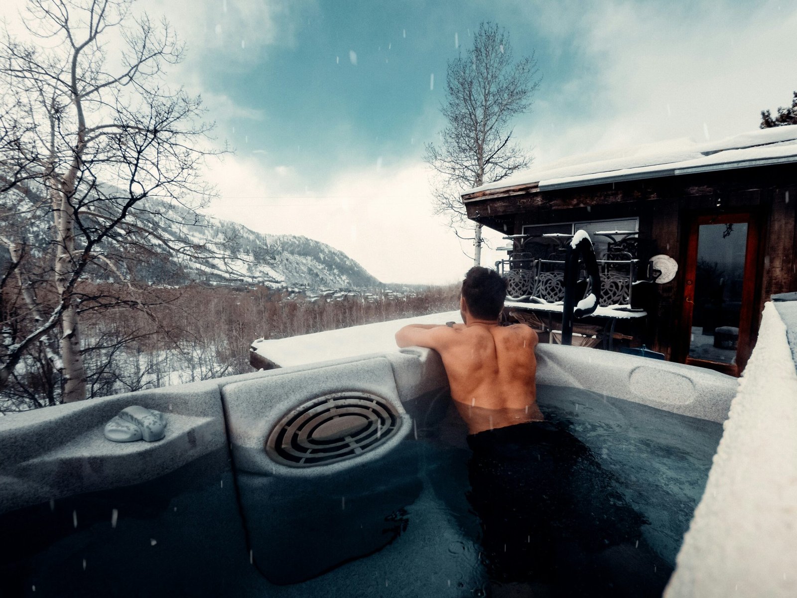 Luxury mountain cabin with a private hot tub in winter, the type of Park City vacation rental amenity that drives bookings and premium nightly rates.